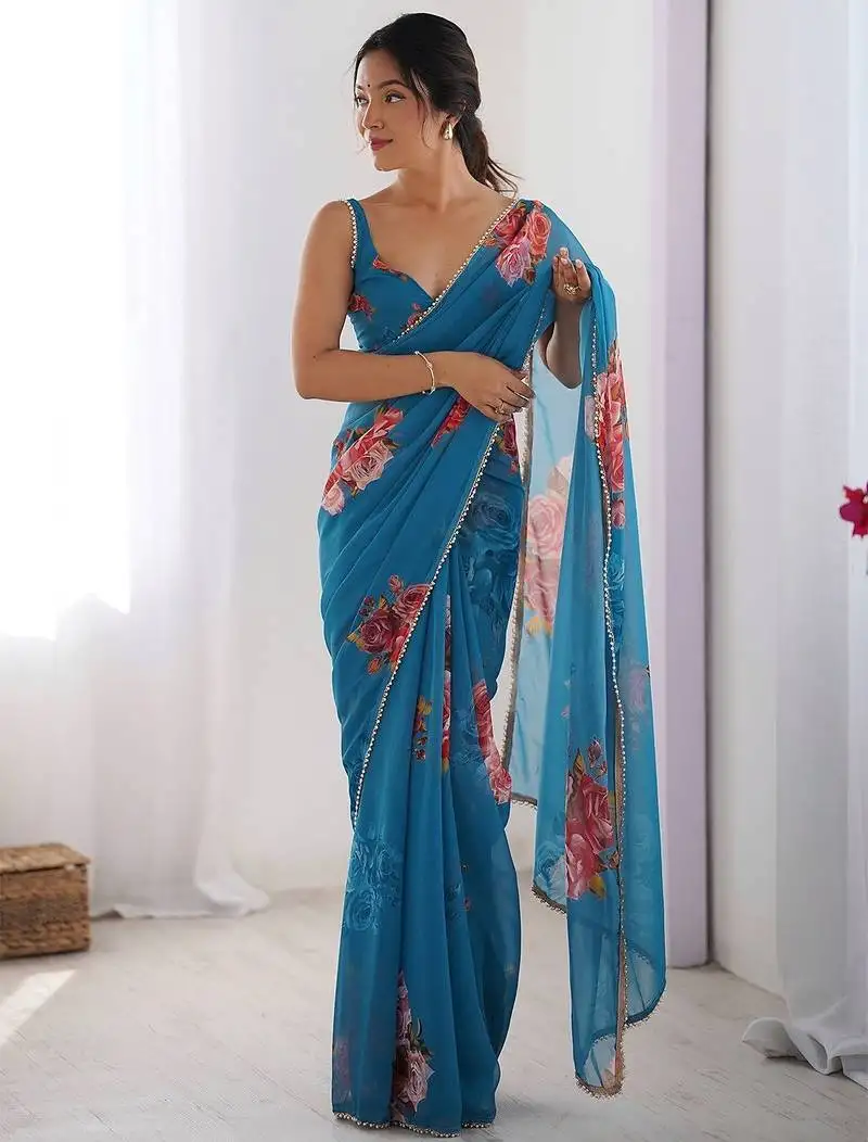 Trendy teal blue georgette silk printed saree with designer moti lace border