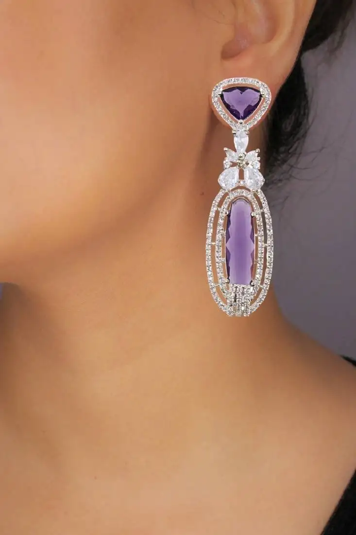 Rhodium plated purple stone zircon studded dangler earrings