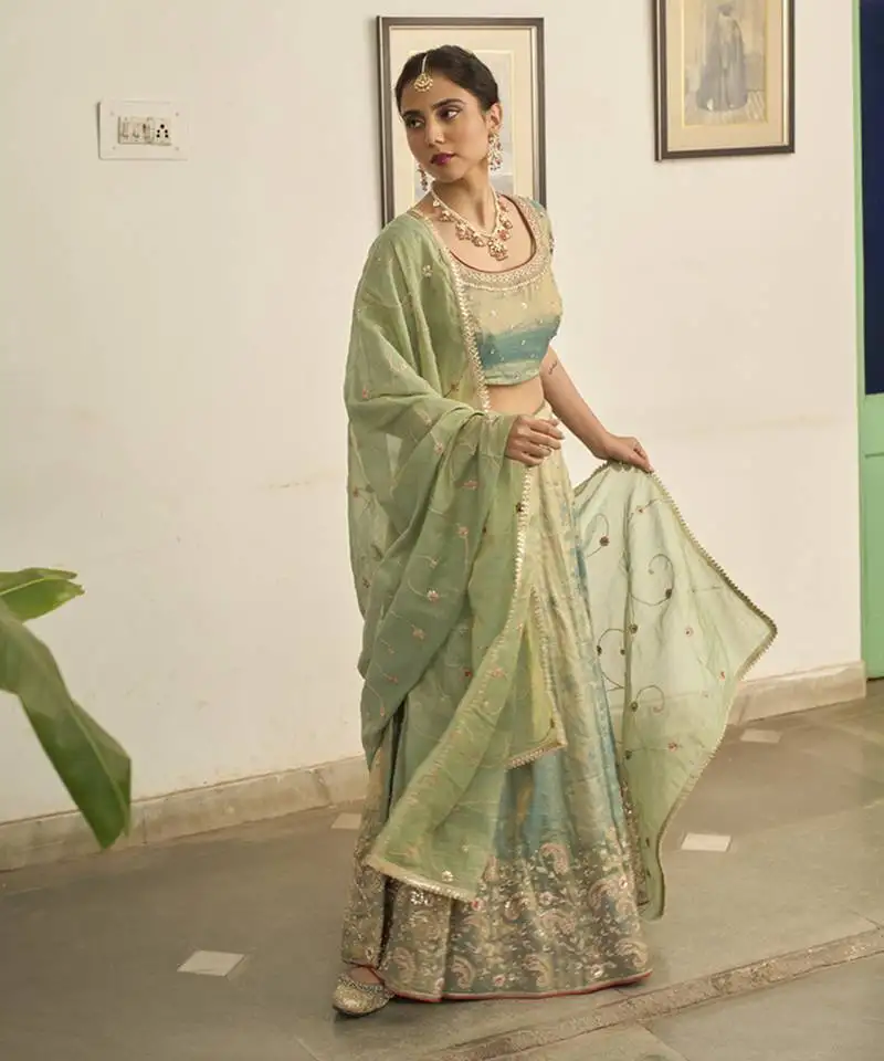 Turquoise embroidered tissue lehenga