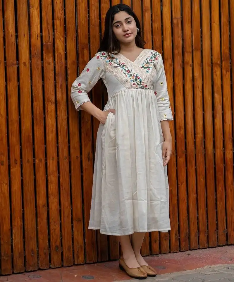 Off-white cotton kurti designed with floral embroidery and crochet lace detailing