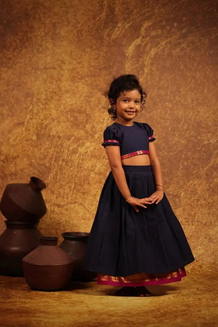 Blue crop top and skirt combo in the tradition of old pattu pavada sets.