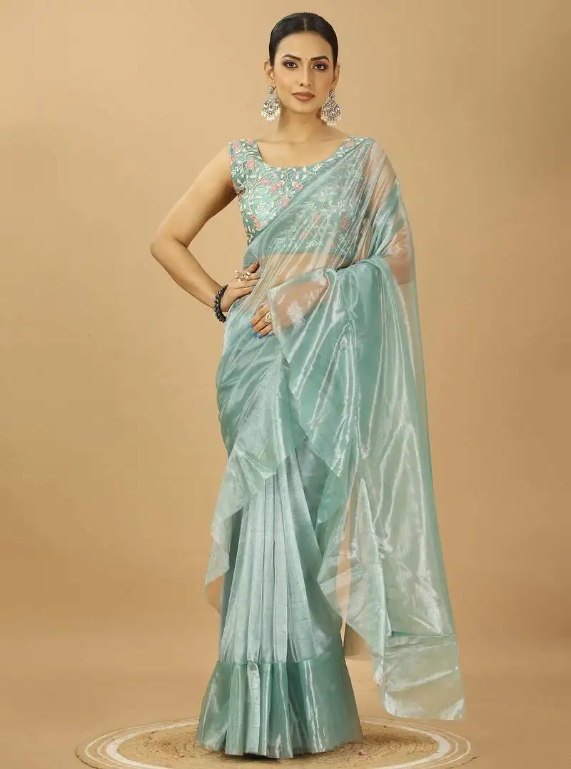 Sea green ruffle style twill net saree with thread embroidered blouse