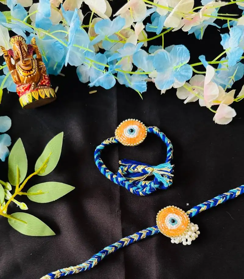 Vibrant evil eye-inspired bhaiya bhabhi rakhi set with beads & braided thread