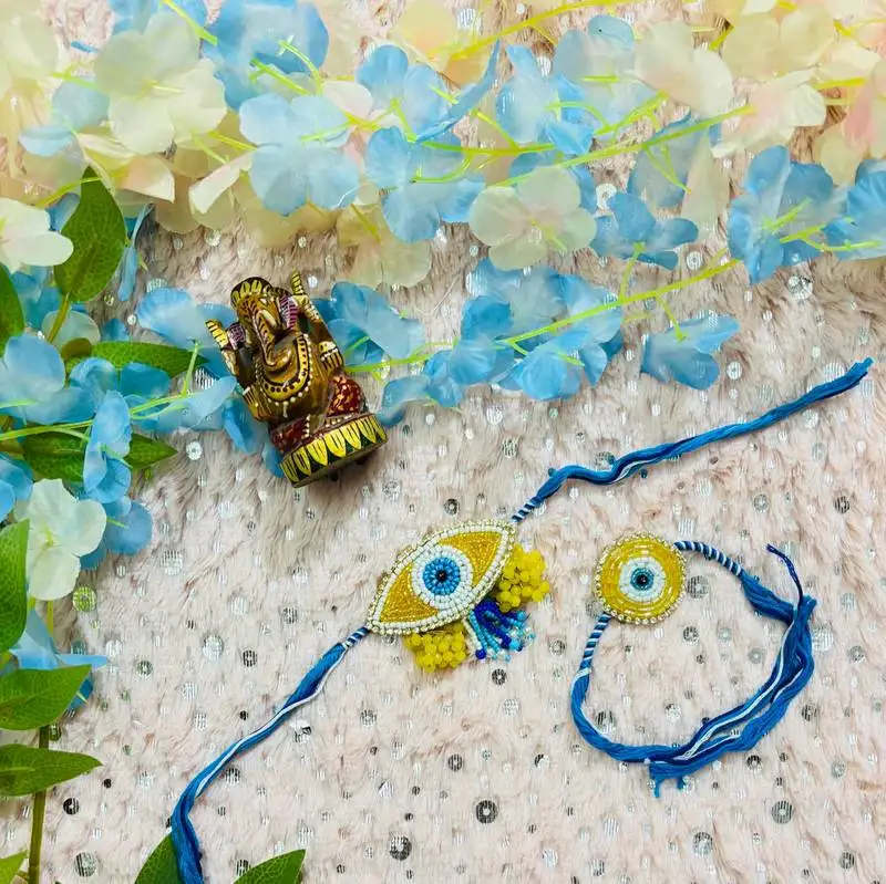 Blue evil eye bhaiya bhabhi rakhi set with bead work & yellow floral accents