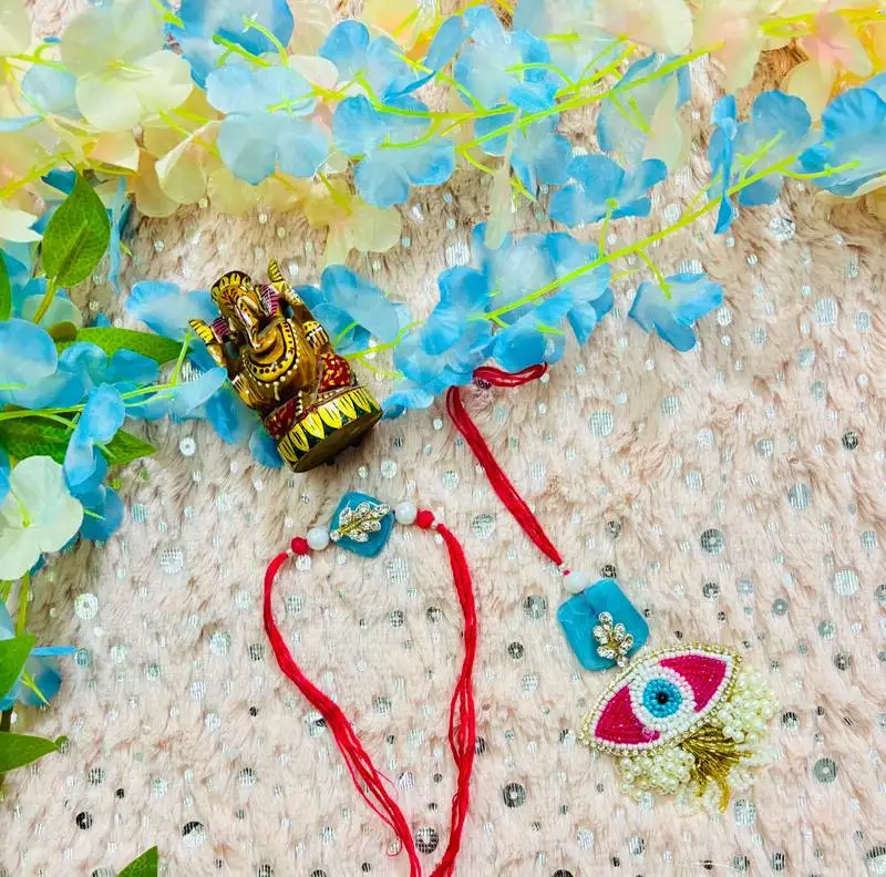 Elegant evil eye bhaiya bhabhi rakhi set with blue stone base & pearl tassels