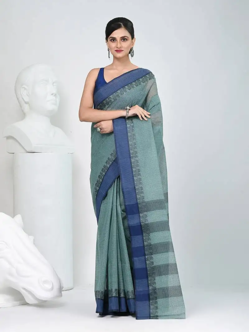 Elegant teal and navy blue striped tant saree with floral border
