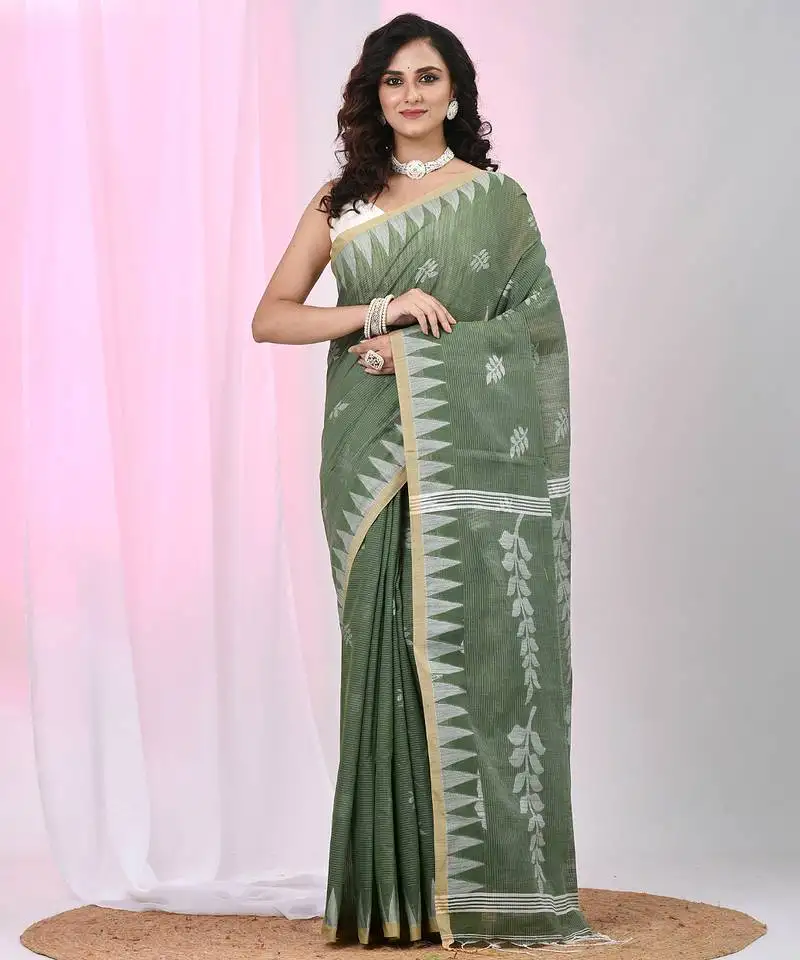 Handspun cotton saree in sage green with leaf and geometric patterns