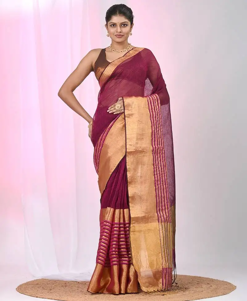 Elegant magenta and gold linen saree with striped borders