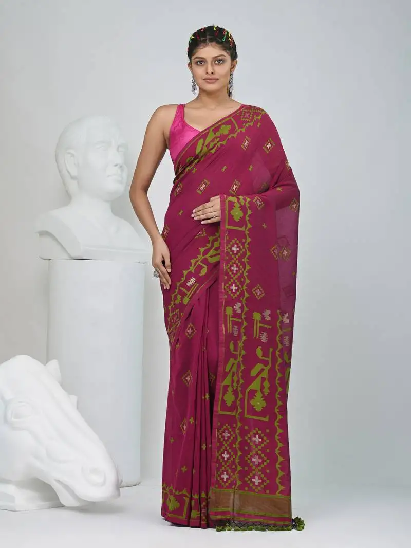 Magenta cotton saree with traditional woven patterns and tassel border