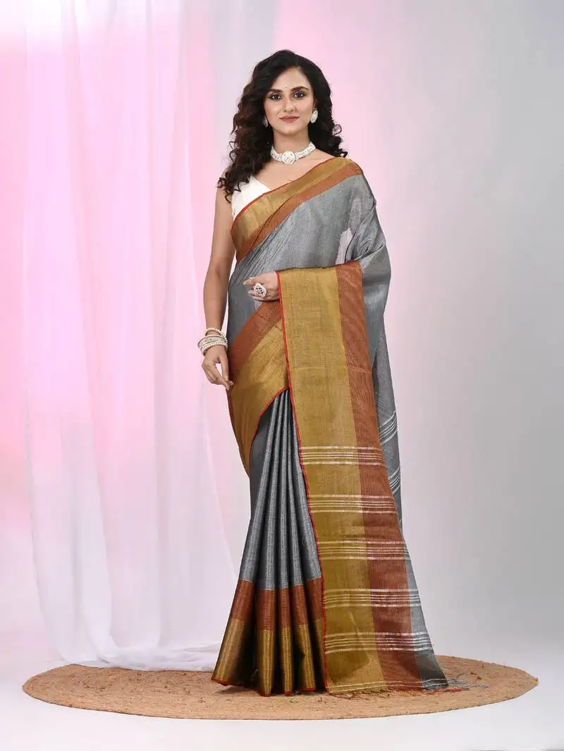 Elegant grey tissue saree with contrasting golden border