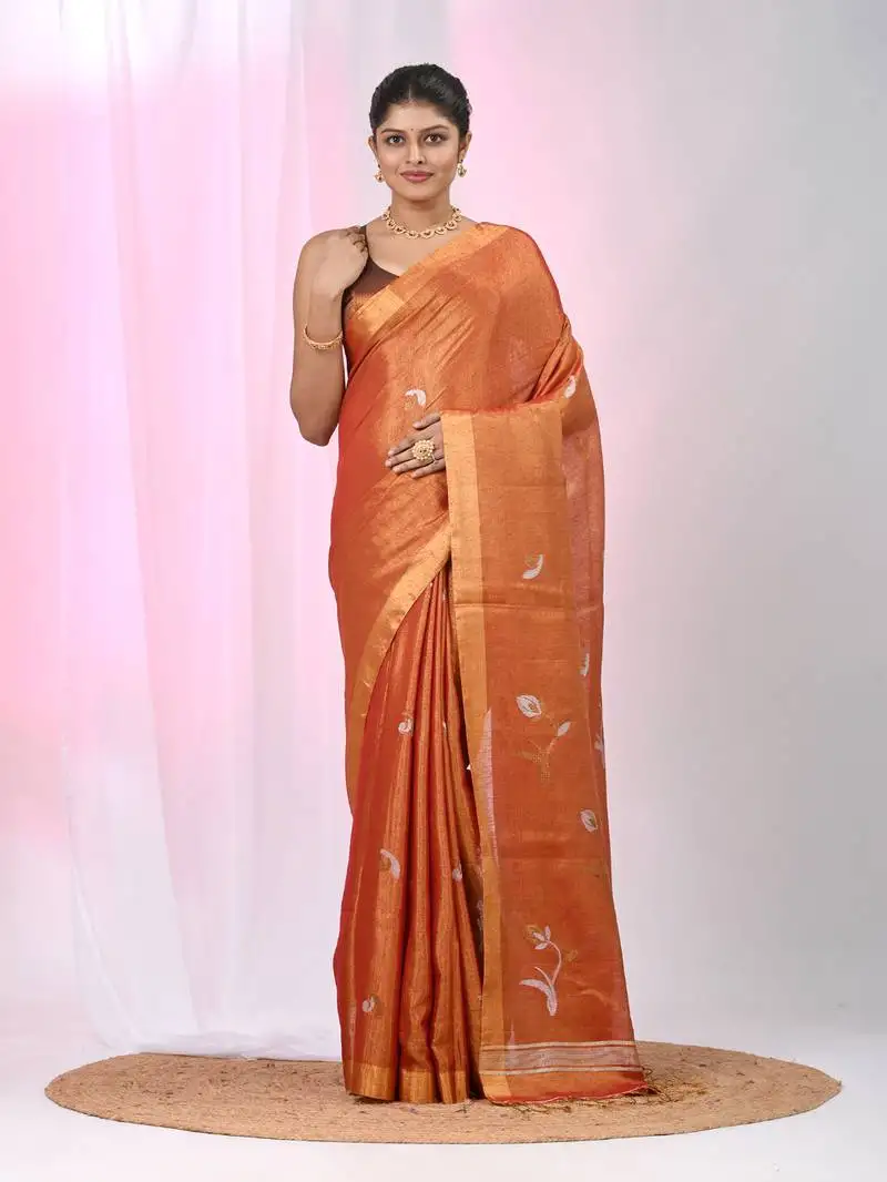 Orange tissue saree with ethnic motifs and golden border