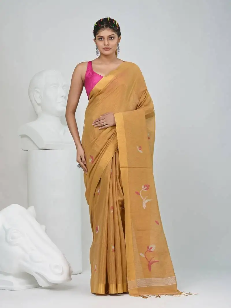 Beige tissue saree with ethnic motifs and golden border
