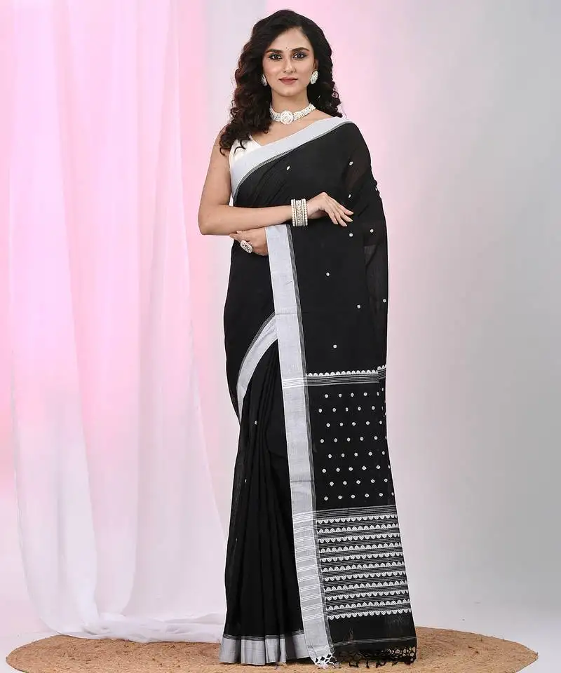 Black cotton saree with white border and woven patterns