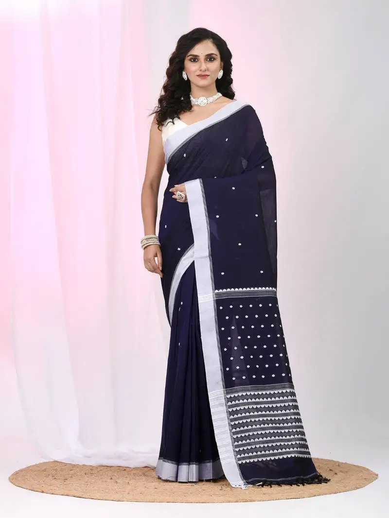 Dark purple cotton saree with white border and woven patterns