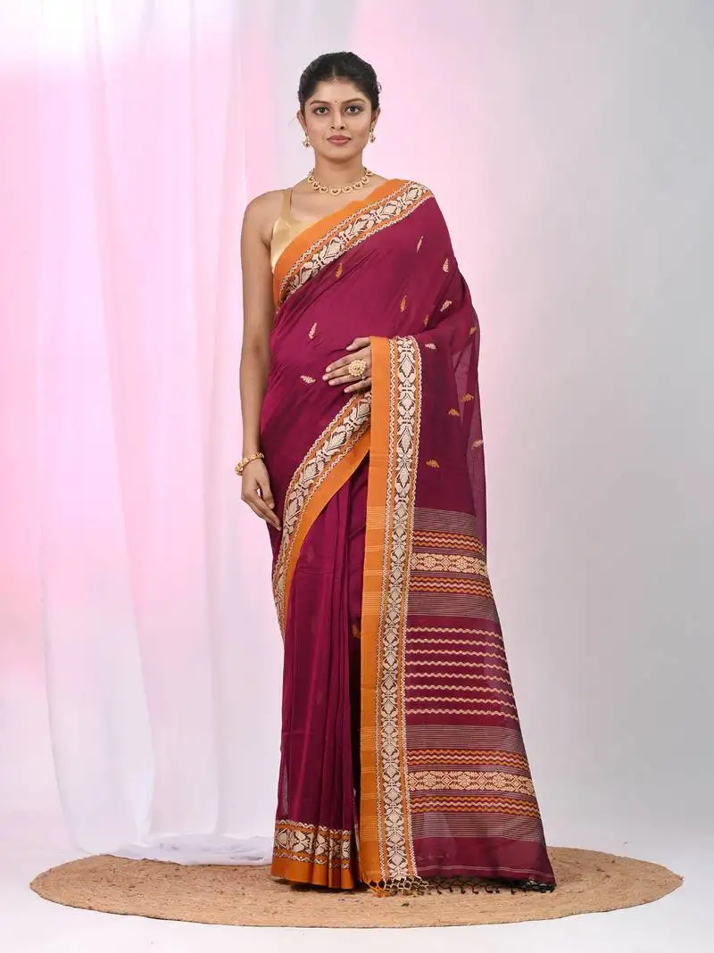 Magenta cotton saree with contrasting yellow border and tassels