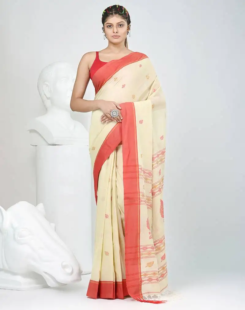 Beige cotton saree with red border & woven leaf motifs