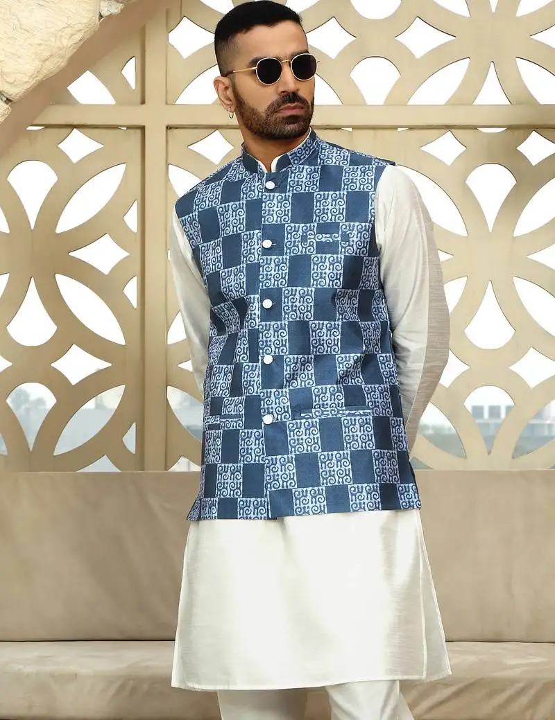Silk blend solid cream kurta and churidar with blue printed nehru jacket