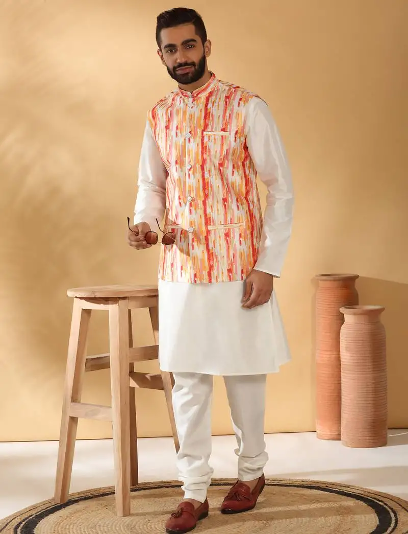 Silk blend cream kurta and churidar with tie-dye orange nehru jacket