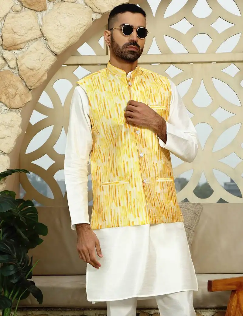 Silk blend solid cream kurta and churidar with tie-dye yellow nehru jacket
