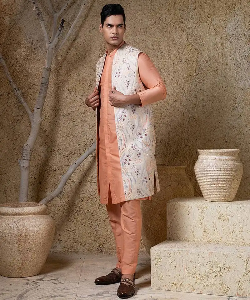 White embroidered cotton silk jacket paired with orange kurta & pant