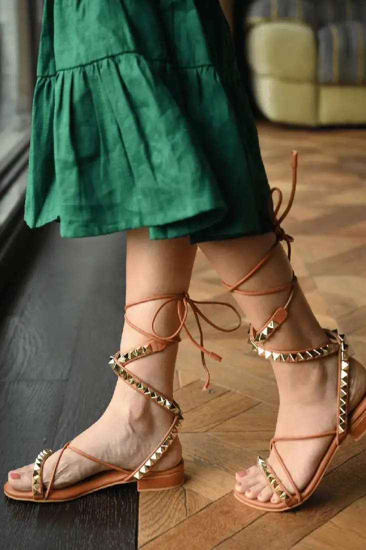 Tie-up flats with gold studs.