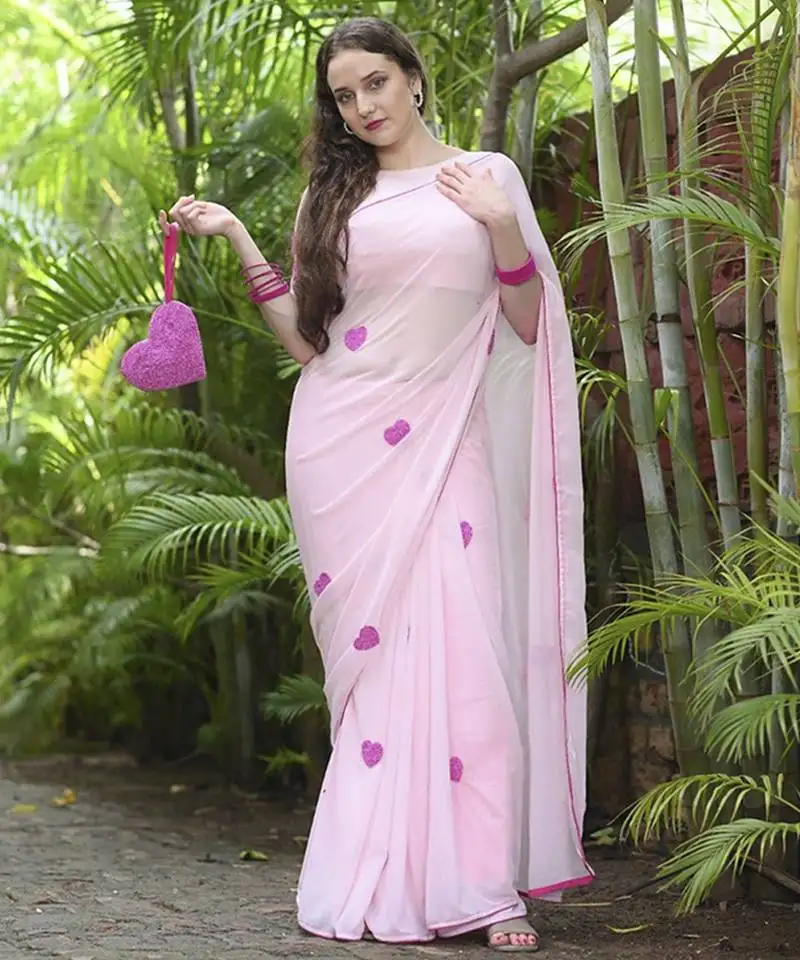 Pink plain georgette saree featuring heart motifs