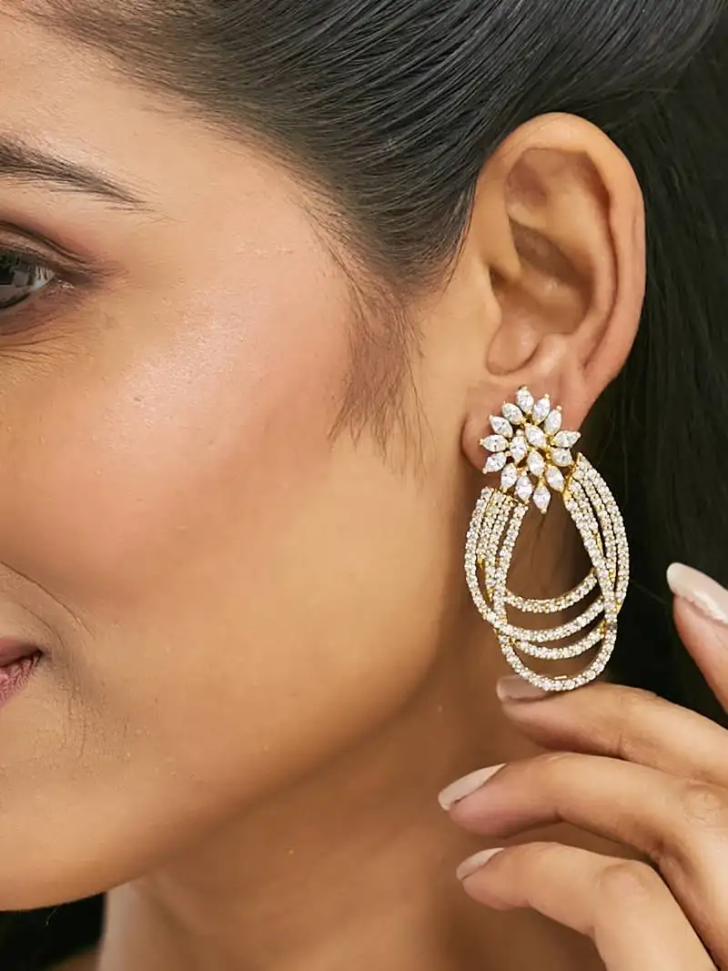 Gold plated floral motif zircon stone studded teardrop shaped elegant drop dangler earrings