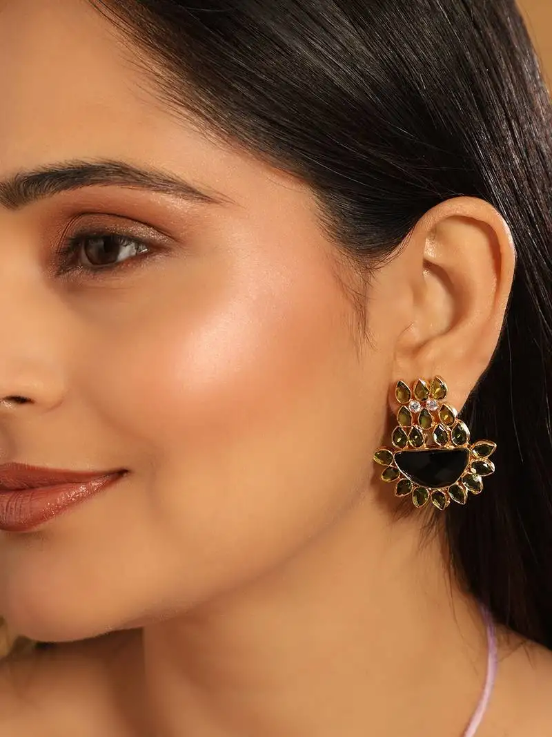 Gold plated dark crystal studded contemporary floral shaped stud earrings