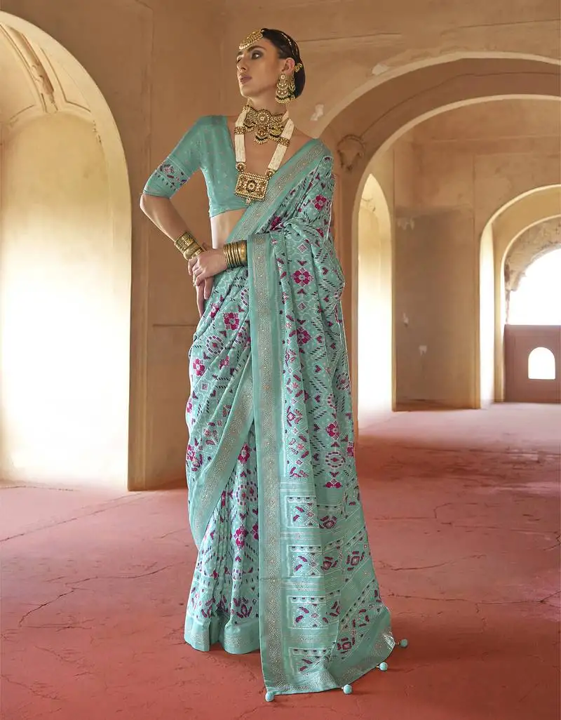 Turquoise poly viscose silk patola printed saree with heavy dimond swarovski work border