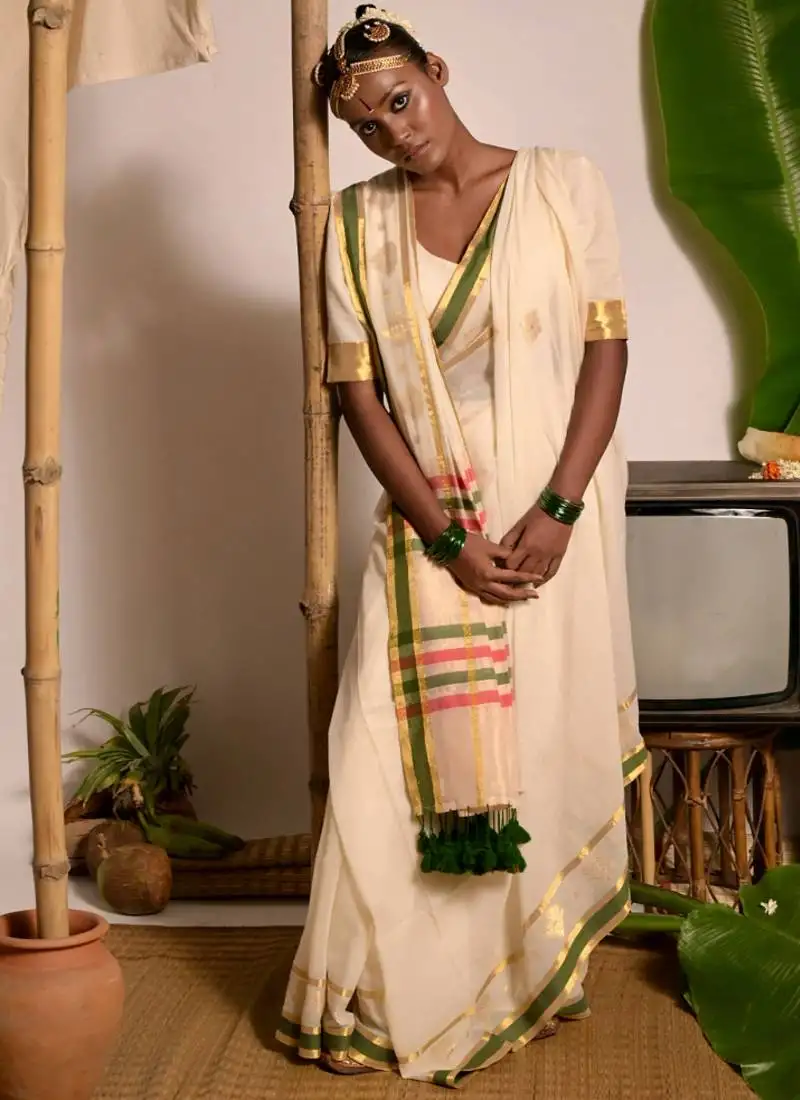 Off white handwoven mul cotton saree with green and zari border