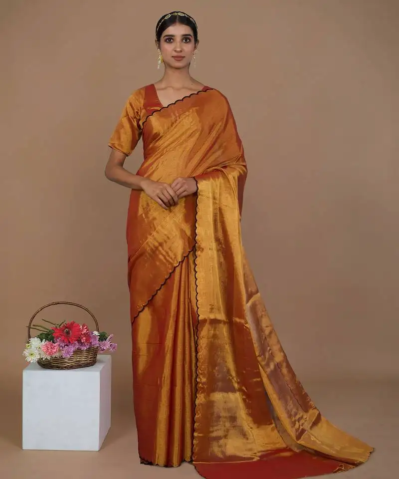 Rust gold handwoven tissue saree with scalloped pallu and border