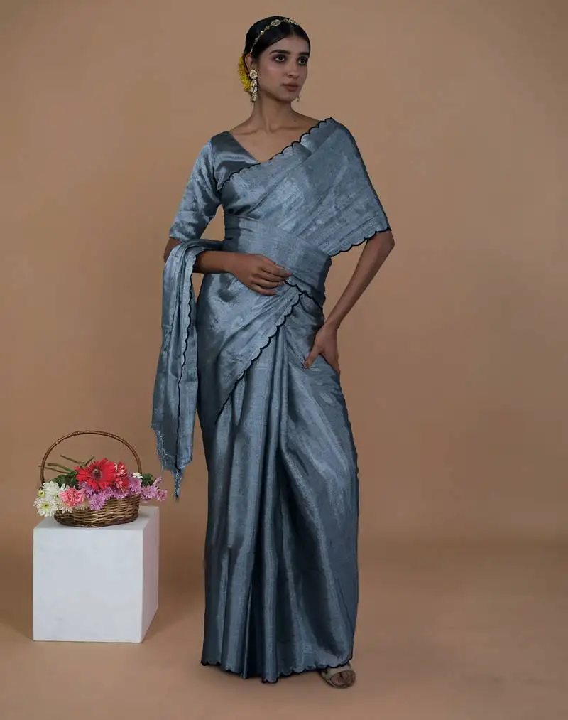 Silver handwoven tissue saree with scalloped pallu and border