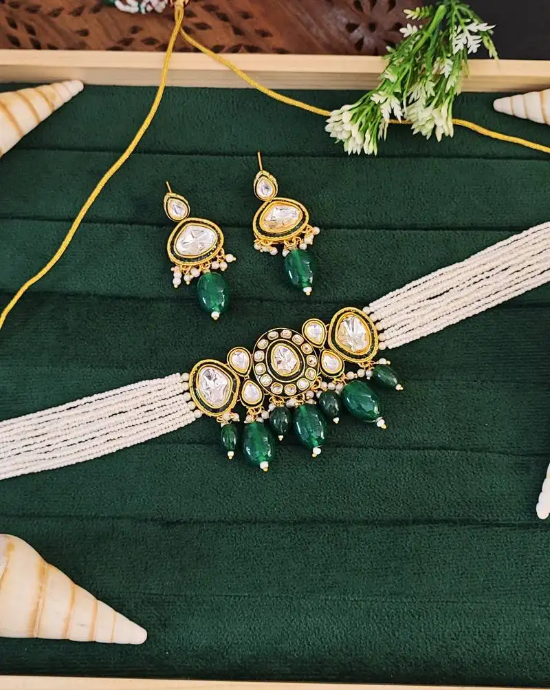 Traditional kundan choker necklace and earring set with green emerald drops, pearl beaded string, gold-plated