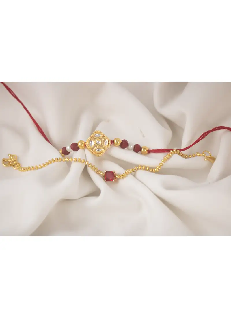 Combo of gold plated kundan couple pair rakhi raksha bandhan with roli chawal and written greeting note.