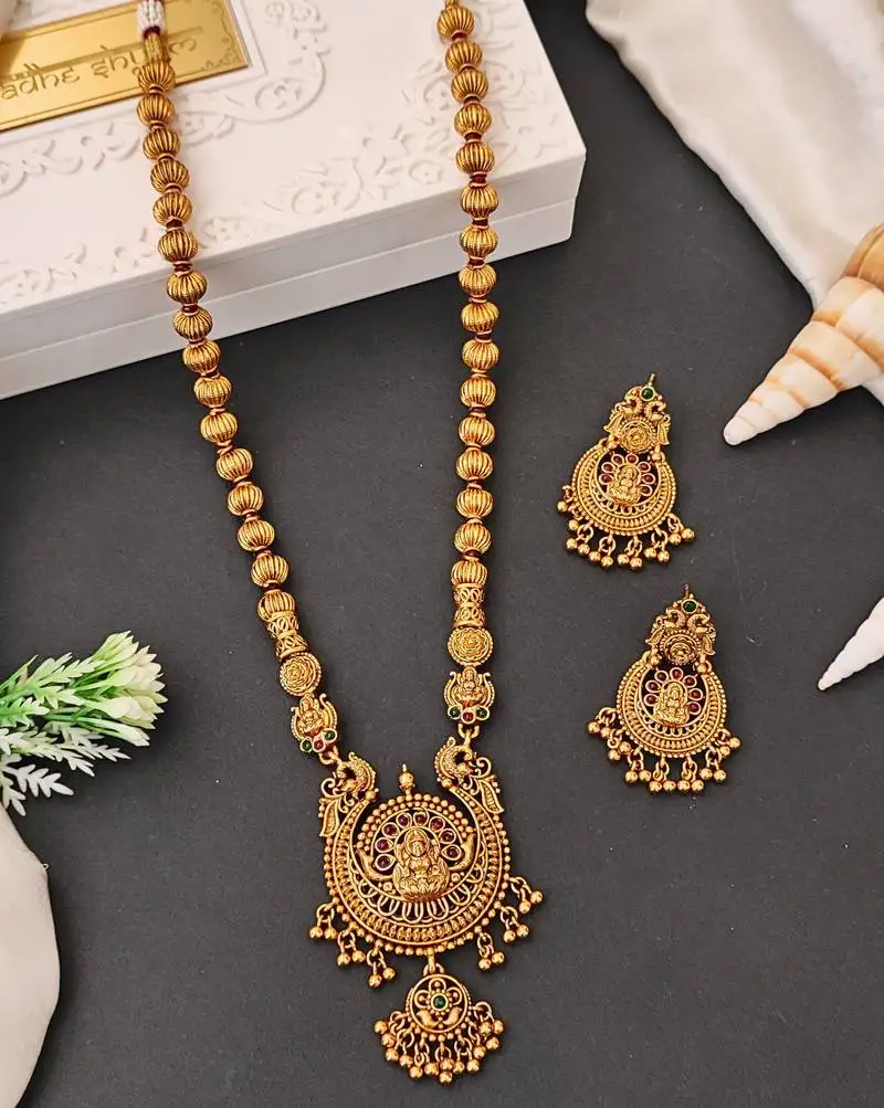 Antique gold plated temple jewelry necklace set with lakshmi pendant and earrings for bridal and ethnic wear