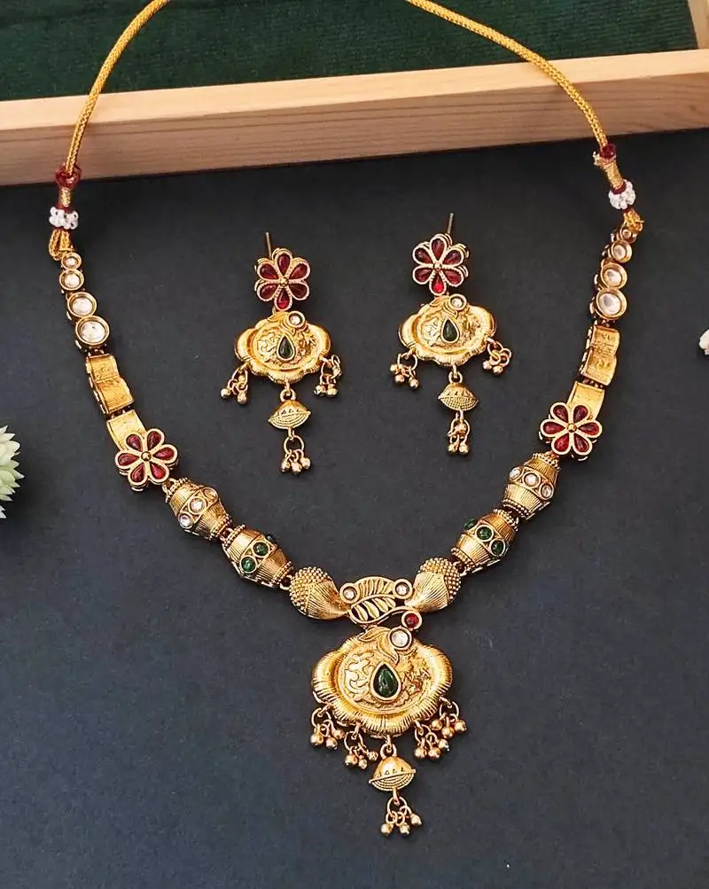 Ethnic gold floral necklace set with red and green enamel accents
