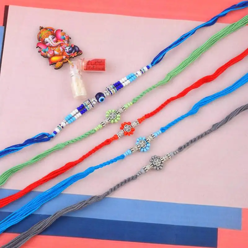 Rakhi for bhaiya bhabhi-pure silver charm 4 rakhi and one evil eye rakhi set (pack of 5)