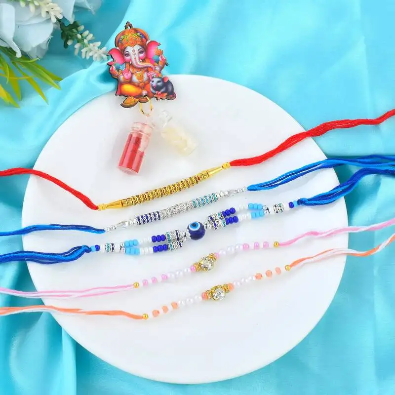 Rakhi for bhaiya bhabhi-pearl, cz and evil eye rakhi set for rakshabandhan with silver coin (pack of 5)