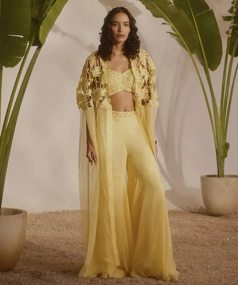 Yellow plain organza pant paired with embroidered blouse and cape