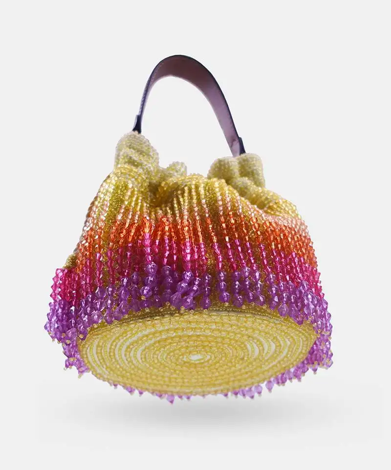 Handcrafted yellow ombre potli bag with crystal fringes and drawstring closer