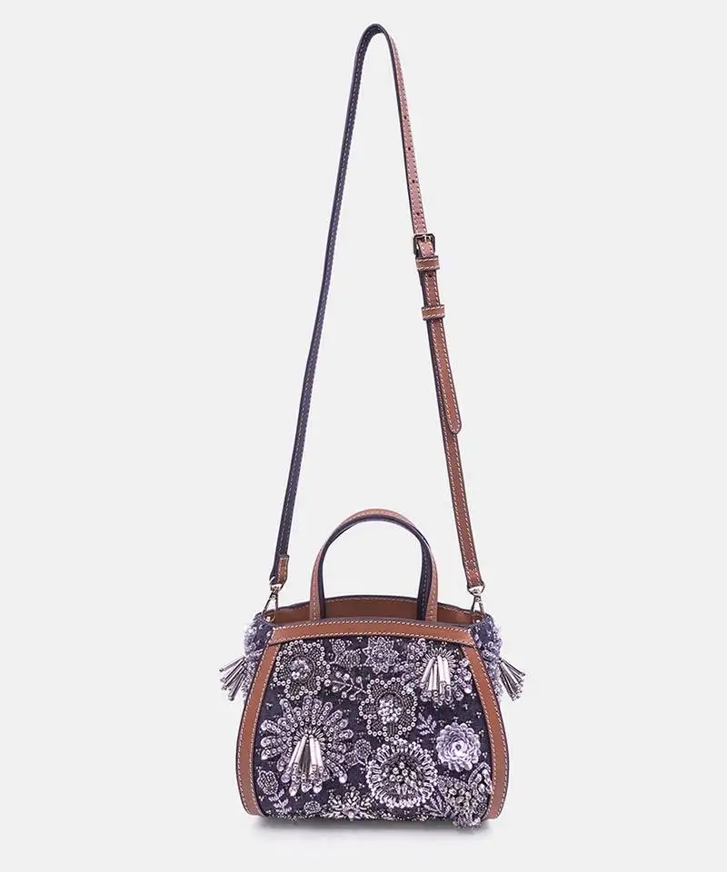 Silver embroidered bead-embellished clutch bag with crossbody strap.