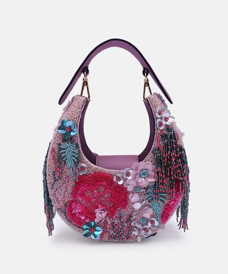 Pink bead-embellished clutch bag with detachable leather crossbody strap