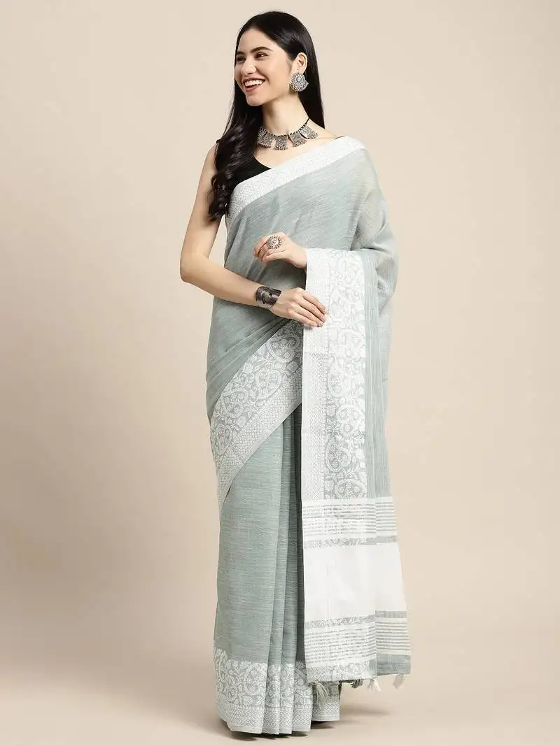 sea green woven linen saree with contrast zari border & tassels