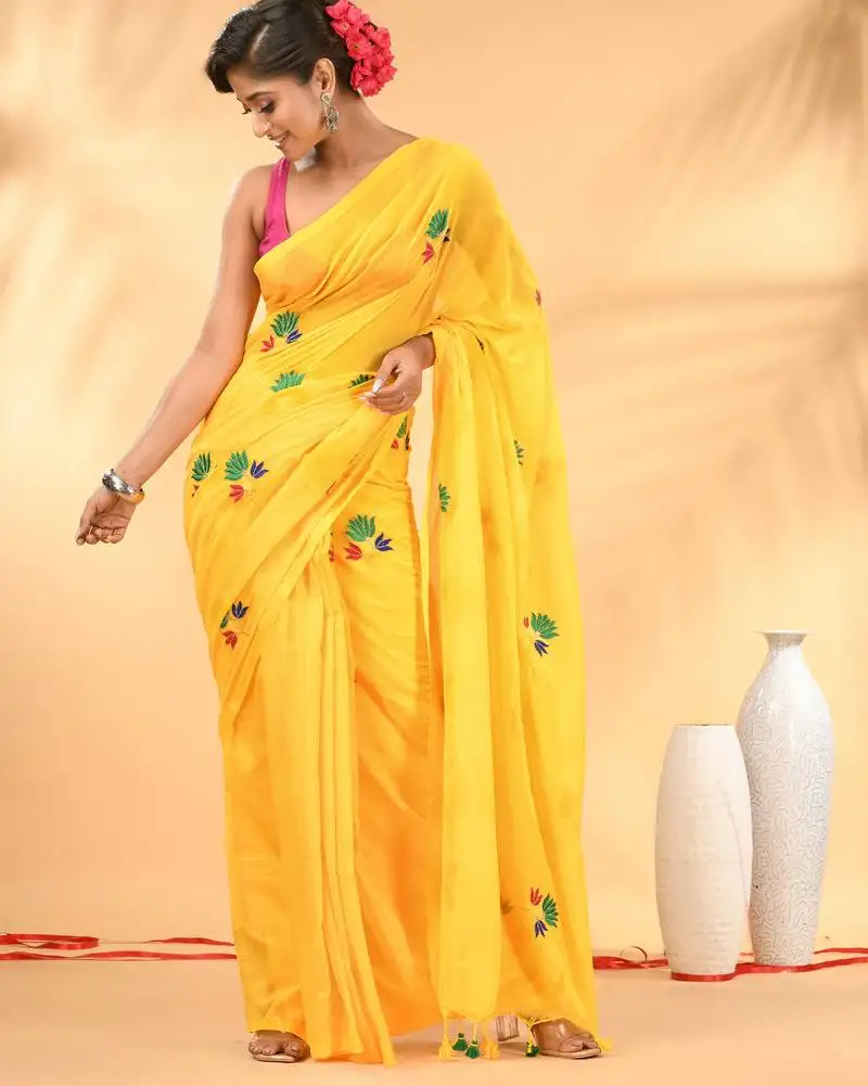 Yellow mulmul cotton saree with floral embroidery and tassel detailing