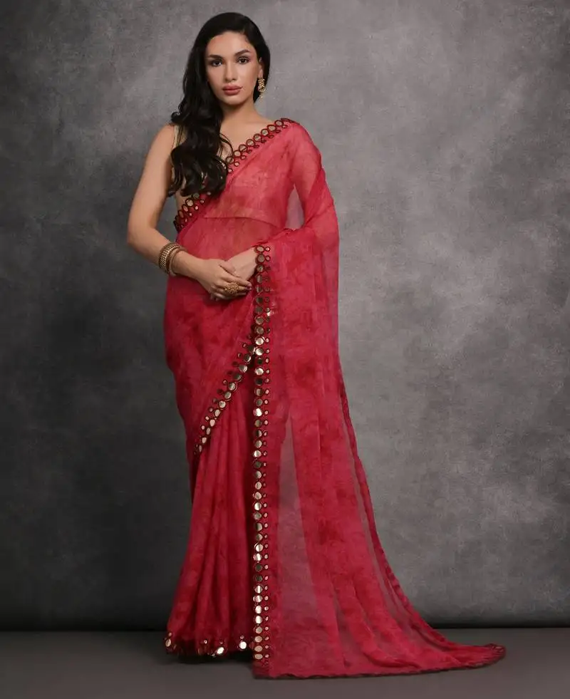Pink printed georgette saree with mirror work border