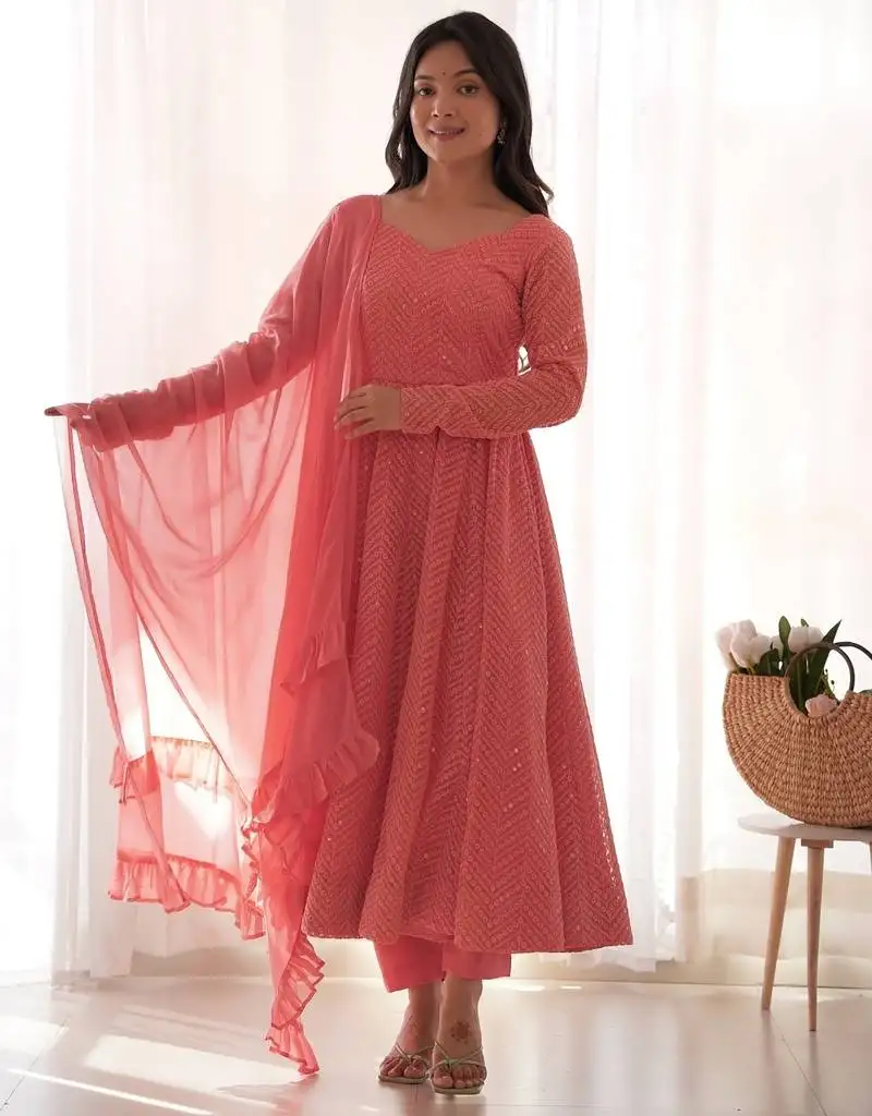 Charming pink anarkali suit with all-over embroidery, ruffled net dupatta, and matching pants  ideal for festive looks. stitched