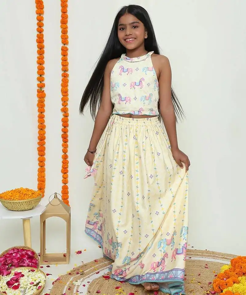 Butter yellow with carasouel print::Lehenga with halter neck blouse