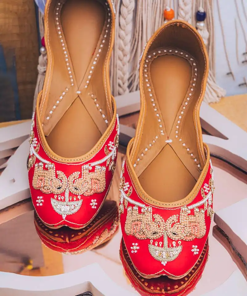 Red embroidered leather juttis