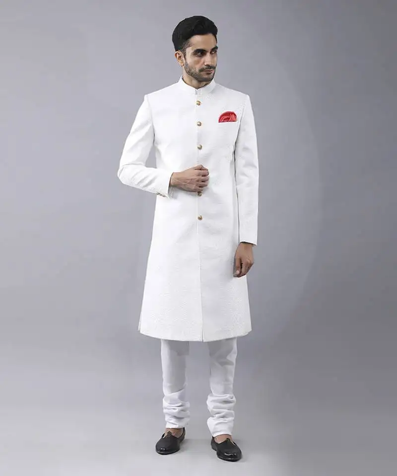 White brocade solid sherwani paired with kurta & churidaar