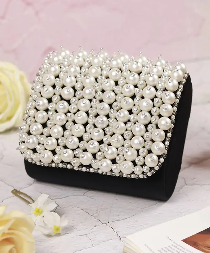 Black suede mini bag with embroidered handle